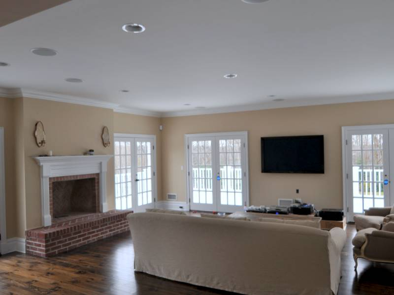 Family Room with Brick Fireplace, Marvin Patio Doors, & Wide Plank Pine Flooring.